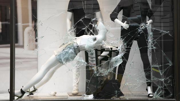 A mannequin behind a window broken by protesters in an Express store on June 1, in the Greenwich Village neighbourhood of New York. (Mark Lennihan / AP )