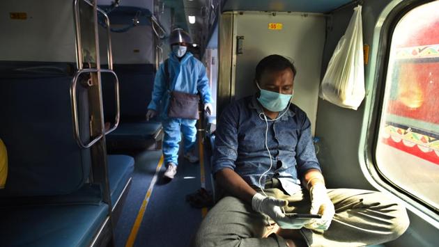A man wearing facemask and hand gloves, looks at his mobile phone on board a Delhi-Chennai Rajdhani Express train. (Raj K Raj / HT Photo) A man wearing facemask and hand gloves, looks at his mobile phone on board a Delhi-Chennai Rajdhani Express train. (Raj K Raj / HT Photo)