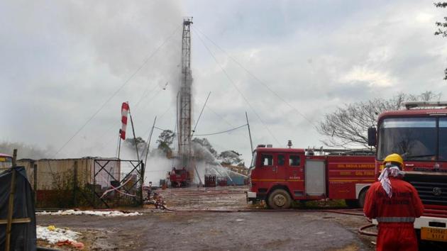An Oil India Limited (OIL) firefighter oversees works near an oil well site following the May 27 blast at the Baghjan oil field of Tinsukia district, some 550 Kms from Guwahati. (AFP photo) An Oil India Limited (OIL) firefighter oversees works near an oil well site following the May 27 blast at the Baghjan oil field of Tinsukia district, some 550 Kms from Guwahati. (AFP photo)