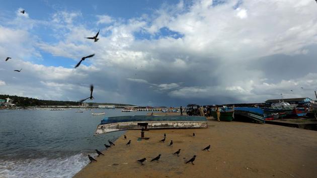 Crows near on upturned boat as clouds gather over Vizhinjam in Thiruvananthapuram on June 1. A normal monsoon is defined by the Met department as 96 to 104% of LPA and above normal as 104 to 110% of LPA. (Vivek Nair / HT Photo)