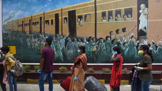 Passengers queue outside Howrah railway station to board a Patna bound train. While social distancing norms were maintained at most places, the stations were not bereft of long queues as the hustle-bustle returned to the train stations. (Samir jana / HT Photo) Passengers queue outside Howrah railway station to board a Patna bound train. While social distancing norms were maintained at most places, the stations were not bereft of long queues as the hustle-bustle returned to the train stations. (Samir jana / HT Photo)