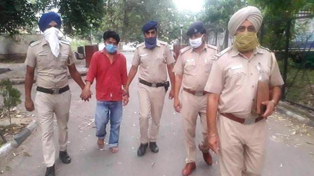 Karan, the murder accused, in police custody in Chandigarh on Tuesday. (HT Photo) Karan, the murder accused, in police custody in Chandigarh on Tuesday. (HT Photo)