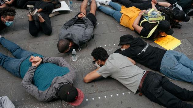 Demonstrators stage a momentary die-in and chant protest in Times Square denouncing racism in law enforcement and the May 25 killing of George Floyd while in the custody of Minneapolis police, on June 1 in New York City. (Scott Heins / Getty Images / AFP)