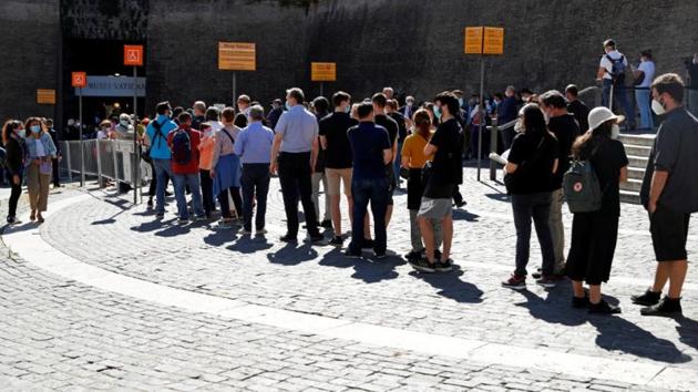 People wearing protective face masks queue to enter the Vatican Museum on June 1. Some 1,600 people had reserved tickets in advance to see the Sistine Chapel on the first day the Vatican Museum re-opened doors to the public after a three-month coronavirus shutdown. (Guglielmo Mangiapane / Reuters )