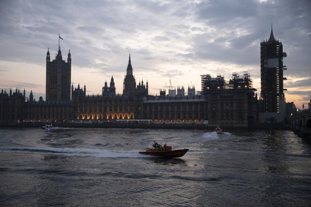 A lifeboat leaves after it and other emergency service boats gathered on the River Thames and a scaffolded Big Ben in London, during the lockdown to try and stop the spread of coronavirus. (AP) A lifeboat leaves after it and other emergency service boats gathered on the River Thames and a scaffolded Big Ben in London, during the lockdown to try and stop the spread of coronavirus. (AP)