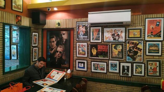 A customer flips through the menu at The Big Chill Cafe at Khan Market.(Kabir Singh Bhandari)