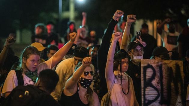 Nearly 700 people were arrested overnight, and several officers were injured. A sergeant was struck by a hit-and-run driver in the Bronx and was hospitalized in serious but stable condition, police said.(AP Photo)