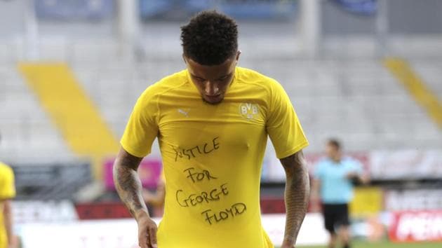 Jadon Sancho of Borussia Dortmund celebrates scoring his teams second goal of the game with a 'Justice for George Floyd' shirt.(AP)