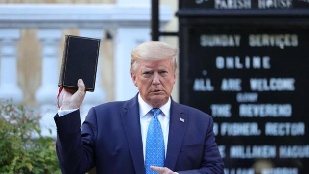 US President Donald Trump holds up a Bible during a photo opportunity in front of St. John's Episcopal Church in the midst of ongoing protests over racial inequality in the wake of the death of George Floyd while in Minneapolis police custody, outside the White House in Washington.(Reuters Photo) US President Donald Trump holds up a Bible during a photo opportunity in front of St. John's Episcopal Church in the midst of ongoing protests over racial inequality in the wake of the death of George Floyd while in Minneapolis police custody, outside the White House in Washington.(Reuters Photo)