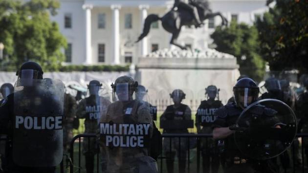 DC National Guard military police officers look on as demonstrators rally near the White House against the death in Minneapolis police custody of George Floyd, in Washington, DC, US.(Reuters)