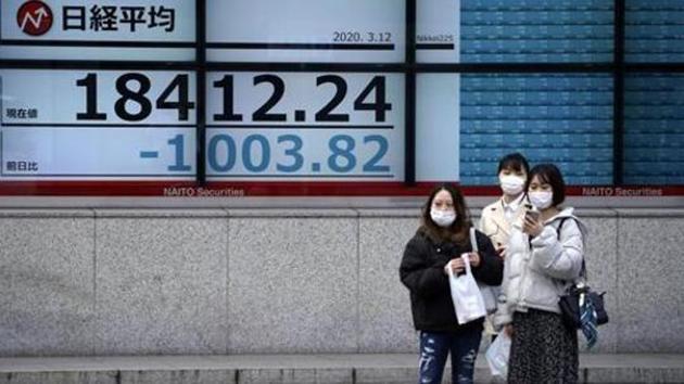 Women stand in front of at an electronic stock board showing Japan's Nikkei 225 index at a securities firm in Tokyo. (AP File Photo) Women stand in front of at an electronic stock board showing Japan's Nikkei 225 index at a securities firm in Tokyo. (AP File Photo)