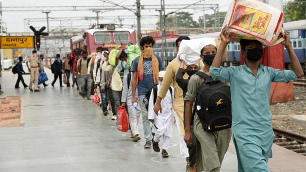 Migrants who arrived from Ghaziabad on a Shramik special train exit Danapur station, in Patna, Bihar. (Santosh Kumar/HT Photo)
