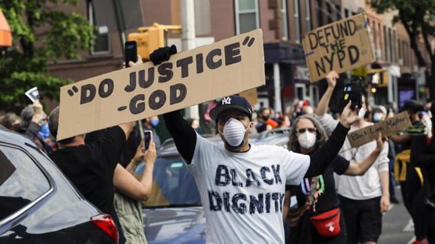 Omar Fernandez takes part in the Prayerful Protest march for George Floyd in the Brooklyn borough of New York. Floyd died after being restrained by Minneapolis police officers on Memorial Day, May 25.(AP Photo) Omar Fernandez takes part in the Prayerful Protest march for George Floyd in the Brooklyn borough of New York. Floyd died after being restrained by Minneapolis police officers on Memorial Day, May 25.(AP Photo)