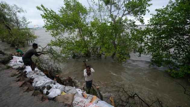 The water will gush into the villages through the breaches in the embankments left behind by Cyclone Amphan inundating new areas. Saline water had gushed into the villages through these gaps destroying farmlands, ponds and huts. (AFP PHOTO.) The water will gush into the villages through the breaches in the embankments left behind by Cyclone Amphan inundating new areas. Saline water had gushed into the villages through these gaps destroying farmlands, ponds and huts. (AFP PHOTO.)