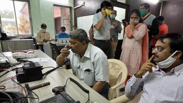 Raigad district officials were seen constantly communicating with IMD, NDRF and local police to ensure evacuation was complete before the earlier informed landfall time of 3pm. (Satish bate / HT Photo) Raigad district officials were seen constantly communicating with IMD, NDRF and local police to ensure evacuation was complete before the earlier informed landfall time of 3pm. (Satish bate / HT Photo)