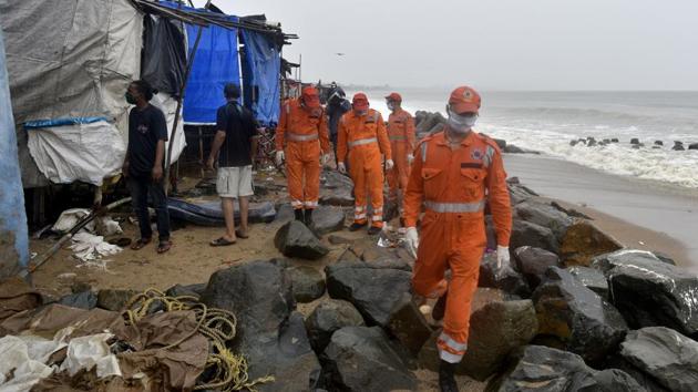 A National Disaster Response Force (NDRF) team deployed in Mumbai evacuated people living along Versova beach just before Cyclone Nisarga barrelled into the city on June 3. (Satyabrata Tripathy / HT Photo) A National Disaster Response Force (NDRF) team deployed in Mumbai evacuated people living along Versova beach just before Cyclone Nisarga barrelled into the city on June 3. (Satyabrata Tripathy / HT Photo)