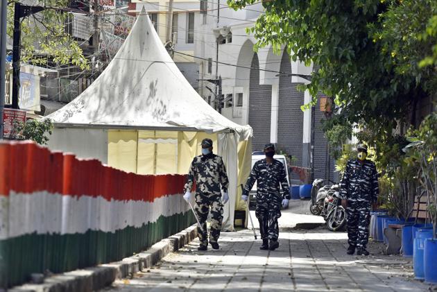 Paramilitary personnel seen at the cordoned off entry route to the Tablighi Jamaat's Alami Markaz Banglewali Masjid building on day twenty of the 21-day nationwide lockdown to curb the spread of coronavirus, in Nizamuddin, New Delhi on April 13, 2020.(Sanjeev Verma/HT PHOTO) Paramilitary personnel seen at the cordoned off entry route to the Tablighi Jamaat's Alami Markaz Banglewali Masjid building on day twenty of the 21-day nationwide lockdown to curb the spread of coronavirus, in Nizamuddin, New Delhi on April 13, 2020.(Sanjeev Verma/HT PHOTO)