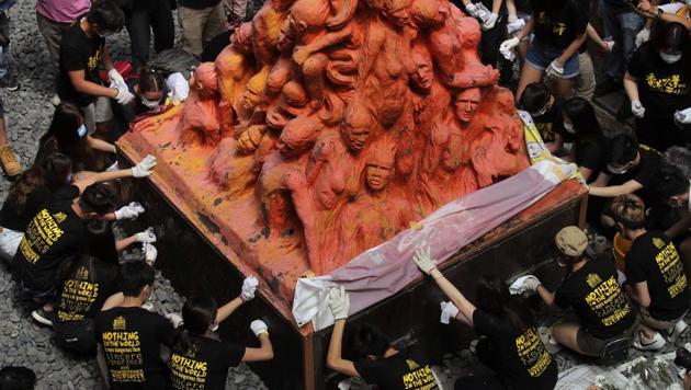 University students clean the "Pillar of Shame" statue, a memorial for those killed in the 1989 Tiananmen crackdown on June 4. China is tightening controls over dissidents while pro-democracy activists in Hong Kong and elsewhere try to mark the 31st anniversary of the crushing of the pro-democracy movement in Beijing's Tiananmen Square. (Kin Cheung / AP) University students clean the "Pillar of Shame" statue, a memorial for those killed in the 1989 Tiananmen crackdown on June 4. China is tightening controls over dissidents while pro-democracy activists in Hong Kong and elsewhere try to mark the 31st anniversary of the crushing of the pro-democracy movement in Beijing's Tiananmen Square. (Kin Cheung / AP)