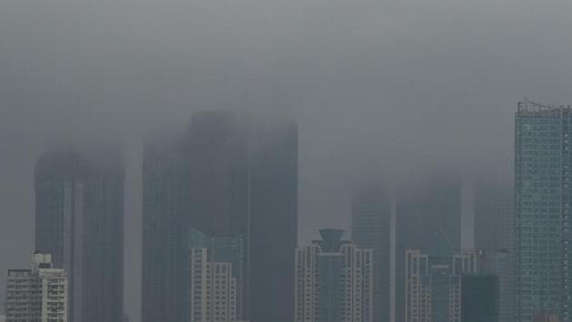 Mumbai’s high rises blanketed by rain clouds on June 4. At least four people were reported dead in the first severe storm to threaten India's financial capital in more than 70 years. (Punit Paranjpe / AFP) 