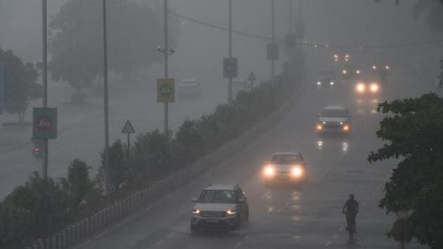 Commuters drive along Marine Drive as rain falls in Mumbai on June 4. Just as in Mumbai, rain has been predicted in isolated spots in Palghar, Thane and Raigad districts. (Punit Paranjpe / AFP) 