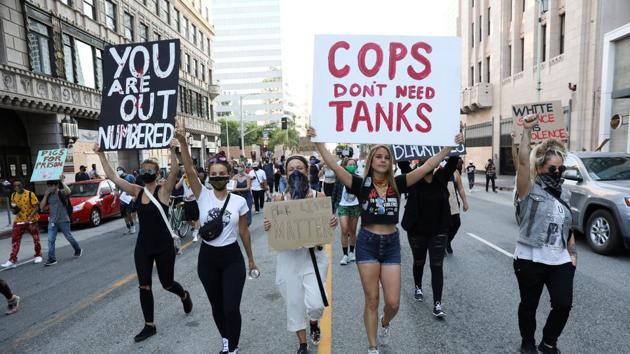 People take part in a protest in response to the death in Minneapolis police custody of George Floyd, in Los Angeles, California on Wednesday.(Reuters Photo) People take part in a protest in response to the death in Minneapolis police custody of George Floyd, in Los Angeles, California on Wednesday.(Reuters Photo)