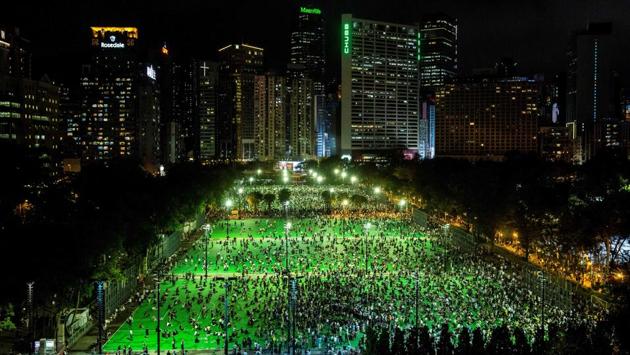 People gather at Victoria Park to commemorate the 31st anniversary of the Tiananmen Square crackdown in Hong Kong. This year’s vigil was banned by authorities, citing coronavirus restrictions on group gatherings. (Isaac Lawrence / AFP) People gather at Victoria Park to commemorate the 31st anniversary of the Tiananmen Square crackdown in Hong Kong. This year’s vigil was banned by authorities, citing coronavirus restrictions on group gatherings. (Isaac Lawrence / AFP)