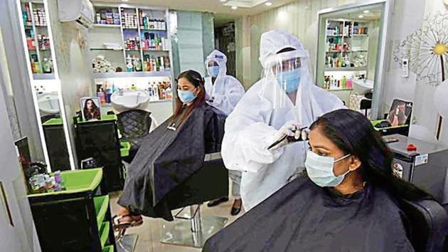 Staff at a Patna salon work wearing PPE.