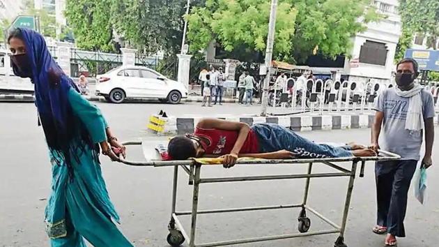 Parents of a non-Covid patient from Maharajganj ran from pillar to post in Lucknow for getting their son admitted to hospital as government hospitals mostly focused on Covid patients and most private hospitals closed shop due to strict guidelines. (HT photo) Parents of a non-Covid patient from Maharajganj ran from pillar to post in Lucknow for getting their son admitted to hospital as government hospitals mostly focused on Covid patients and most private hospitals closed shop due to strict guidelines. (HT photo)