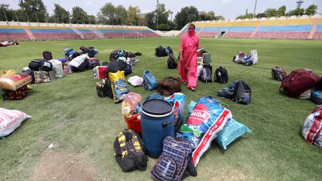 Pieces of luggage laid out in the grounds of the Ambedkar Stadium as migrants complete registration formalities. The majority of trains that have left from Delhi were bound for Uttar Pradesh and Bihar. While there are still migrants wishing to go home, their numbers are too low and destinations scattered to make trains feasible, a senior government official told HT. (ANI)