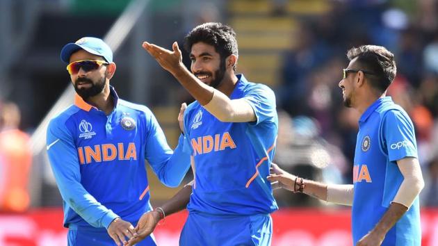 India's Jasprit Bumrah (C) celebrates with India's captain Virat Kohli (L)(AFP)