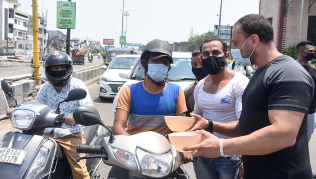 Gym owners begging from commuters, in a symbolic protest, on Jagroan bridge in Ludhiana on Thursday. (GURPREET SINGH/HT) Gym owners begging from commuters, in a symbolic protest, on Jagroan bridge in Ludhiana on Thursday. (GURPREET SINGH/HT)