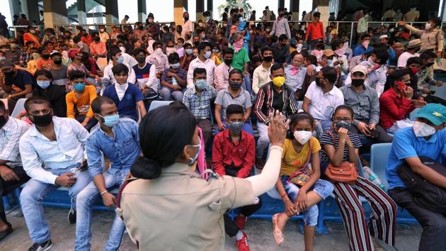 A security personnel coordinates with migrants during screening procedures for onward travel from Ambedkar Stadium in New Delhi on May 31, when the last Shramik Special trains left from the capital’s railway stations. The Delhi government on June 3 said it is unlikely to run any more trains for now due to a drop in the number of people looking to board them. (ANI)