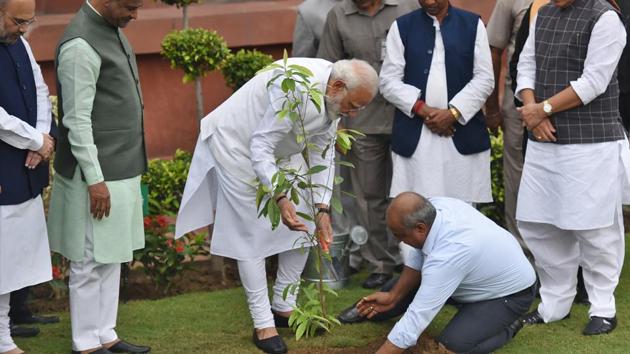 In this file photo, Prime Minister Narendra Modi plants a sapling as part of a plantation campaign, in the presence of Lok Sabha speaker Om Birla, Defence Minister Rajnath Singh and other Members of Parliament, at Parliament House, in New Delhi, on Friday, July 2019.(Raj K Raj/HT PHOTO) In this file photo, Prime Minister Narendra Modi plants a sapling as part of a plantation campaign, in the presence of Lok Sabha speaker Om Birla, Defence Minister Rajnath Singh and other Members of Parliament, at Parliament House, in New Delhi, on Friday, July 2019.(Raj K Raj/HT PHOTO)