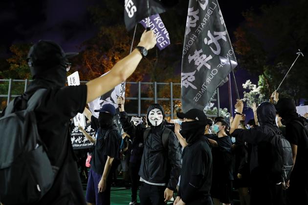 Protesters wearing protective face masks and coverings wave Hong Kong independence flags as they take part in a candlelight vigil to mark the 31st anniversary of the crackdown of pro-democracy protests at Beijing's Tiananmen Square in 1989, after police rejects a mass annual vigil on public health grounds, at Victoria Park, in Hong Kong, China June 4, 2020. REUTERS/Tyrone Siu (REUTERS) Protesters wearing protective face masks and coverings wave Hong Kong independence flags as they take part in a candlelight vigil to mark the 31st anniversary of the crackdown of pro-democracy protests at Beijing's Tiananmen Square in 1989, after police rejects a mass annual vigil on public health grounds, at Victoria Park, in Hong Kong, China June 4, 2020. REUTERS/Tyrone Siu (REUTERS)