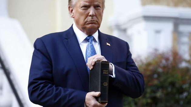 President Donald Trump holds a Bible as he visits outside St. John's Church across Lafayette Park from the White House in Washington. (AP) President Donald Trump holds a Bible as he visits outside St. John's Church across Lafayette Park from the White House in Washington. (AP)