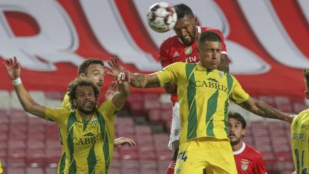 Benfica's Dyego Sousa, top right, heads for the ball with Tondela's Filipe Sampaio, right, during a Portuguese League soccer match between Benfica and Tondela in Lisbon, Portugal, Thursday, June 4, 2020. The Portuguese League soccer matches resumed Wednesday without spectators because of the coronavirus pandemic. (Tiago Petinga/Pool via AP)(AP)