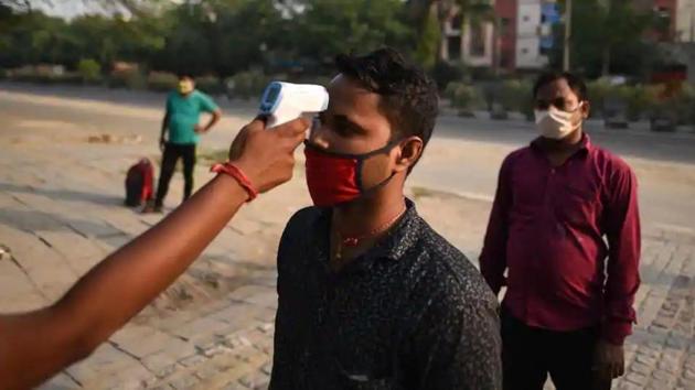 A migrant worker undergoes thermal screening at Delhi’s Yamuna Sports Complex which turned into a shelter home, during nationwide lockdown to curb the spread of coronavirus. (Biplov Bhuyan/HT File Photo) A migrant worker undergoes thermal screening at Delhi’s Yamuna Sports Complex which turned into a shelter home, during nationwide lockdown to curb the spread of coronavirus. (Biplov Bhuyan/HT File Photo)