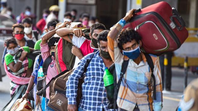 Migrants stand in a queue at Central Railway Station to board a Shramik Special train for West Bengal during ongoing Covid-19 lockdown.(PTI)