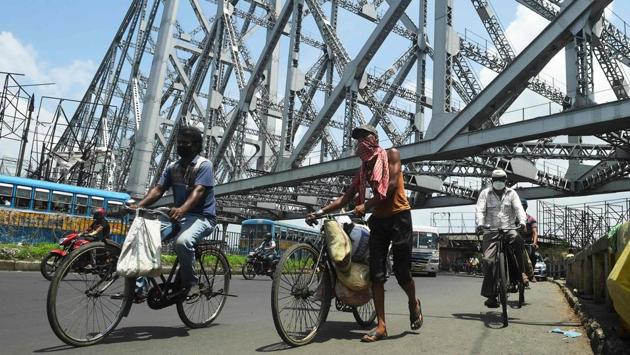 Commuters ride bicycles along the Howrah Bridge to go to work after the government eased the nationwide lockdown imposed as a preventive measure against COVID-19 in Kolkata on June 5. With a record single-day spike of 9,887 cases, the country has registered over 9,000 cases for the third day in a row as of June 5. (Dibyangshu Sarkar / AFP) 