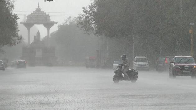 A motorist on a scooter drives through rain near Statue Circle, in Jaipur, Rajasthan. (Photo by Himanshu Vyas/ Hindustan Times) A motorist on a scooter drives through rain near Statue Circle, in Jaipur, Rajasthan. (Photo by Himanshu Vyas/ Hindustan Times)