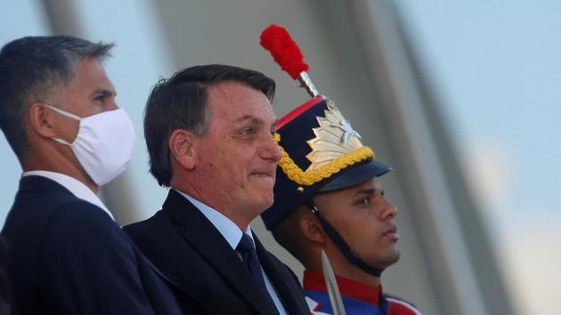 Brazil's President Jair Bolsonaro greets his supporters at the ramp of the Planalto Palace. (REUTERS) Brazil's President Jair Bolsonaro greets his supporters at the ramp of the Planalto Palace. (REUTERS)