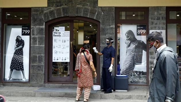 A security personnel thermal screens a woman before allowing entry into a clothing store in Pune, Maharashtra, India, on Friday, June 5, 2020. (Rahul Raut/HT/PHOTO FOR REPRESENTATION ONLY) A security personnel thermal screens a woman before allowing entry into a clothing store in Pune, Maharashtra, India, on Friday, June 5, 2020. (Rahul Raut/HT/PHOTO FOR REPRESENTATION ONLY)