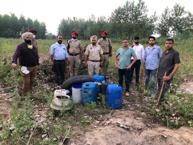 Personnel of the anti-smuggling wing destroying illicit liquor on the banks of Sutlej river in Ludhiana on Sunday (HT PHOTO) Personnel of the anti-smuggling wing destroying illicit liquor on the banks of Sutlej river in Ludhiana on Sunday (HT PHOTO)