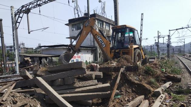 A JCB machine carries out repair work at the level crossing near Diva railway station amid lockdown. A JCB machine carries out repair work at the level crossing near Diva railway station amid lockdown.