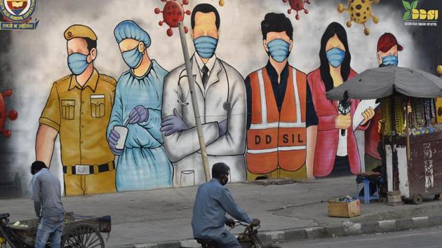 A cyclist rides past a mural paying tribute to frontline coronavirus workers amid the lockdown, near Garhi Chowk, in New Delhi, on Saturday.(Sanjeev Verma/HT Photo) A cyclist rides past a mural paying tribute to frontline coronavirus workers amid the lockdown, near Garhi Chowk, in New Delhi, on Saturday.(Sanjeev Verma/HT Photo)