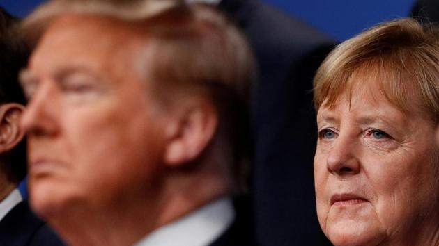 US President Donald Trump and Germany's Chancellor Angela Merkel pose for the family photo during the annual NATO heads of government summit at the Grove Hotel in Watford, Britain. (REUTERS) US President Donald Trump and Germany's Chancellor Angela Merkel pose for the family photo during the annual NATO heads of government summit at the Grove Hotel in Watford, Britain. (REUTERS)