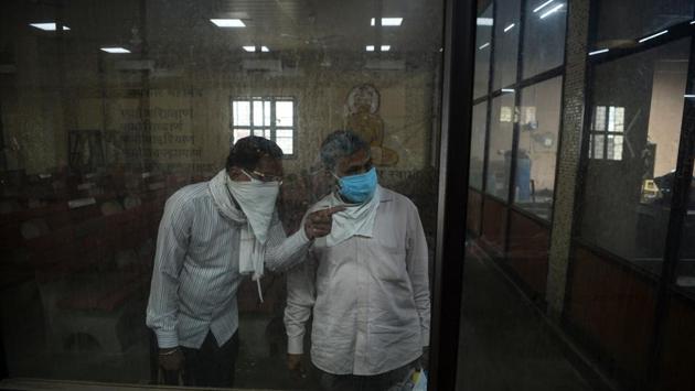 Relatives watch from inside a room as the body of a person who died of COVID-19 is cremated at the Nigambodh Ghat cremation ground. Delhi is one of the hardest-hit states in India from the coronavirus with about 27,654 cases and more than 760 dead as of June 7 according to the covid19india.org tracker. (Sajjad Hussain / AFP)