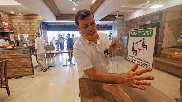Glass partitions on the tables at a Bengaluru restaurant ahead of its reopening. The centre’s guideline include--seating arrangement to be made for adequate social distancing for visitors. And not more than 50% of seating capacity will be permitted. (PTI)