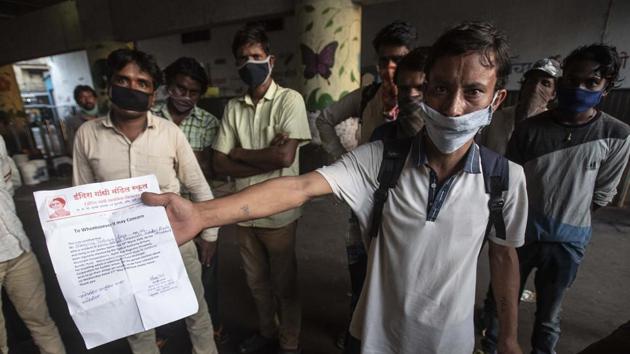 Manojsingh Rana, a migrant worker from Uttarakhand staying in a PMC parking lot near the railway station holds up a fitness certificate and releasing letter from a shelter home in Pune, India, on Friday, May 29, 2020. The letter says Rana wishes to go to his native state of his own will and is being released from the shelter. (Pratham Gokhale/HT Photo) Manojsingh Rana, a migrant worker from Uttarakhand staying in a PMC parking lot near the railway station holds up a fitness certificate and releasing letter from a shelter home in Pune, India, on Friday, May 29, 2020. The letter says Rana wishes to go to his native state of his own will and is being released from the shelter. (Pratham Gokhale/HT Photo)
