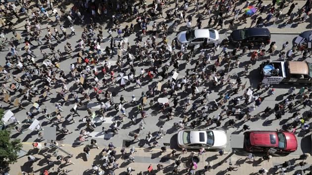 Protesters march in the street on June 7, in St. Louis, Missouri. Community activists have criticized the Minneapolis department for years for what they say is a racist and brutal culture that resists change. However, the move to defund or abolish the Minneapolis department is far from assured, with the civil rights investigation likely to unfold over the next several months. (Jeff Robertson / AP)
